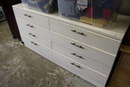 A painted chest of drawers.