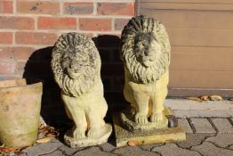 A pair of reconstituted stone figures of lions rampant.