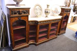 A very good Victorian walnut and marble break front pedestal bookcase with glazed doors.
