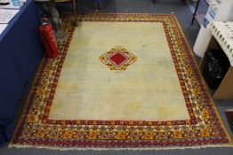 A beige ground Persian carpet.