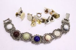 A decorative bracelet and various dress studs.