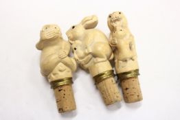 Three amusing animal form bottle stoppers.