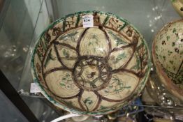Decorative painted and incised Islamic pottery bowl.
