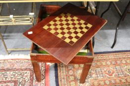 A mahogany games table with removable top.