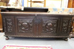 An Italian walnut cassonne, the panelled front with carved decoration.