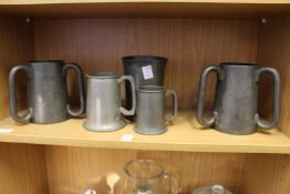 Two pewter tygs, one inscribed Charterhouse 1882 together with three other items of pewter.