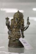 An eastern cast bronze figure of Ganesh.