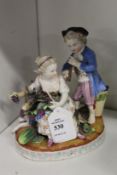 A continental porcelain group of two children, one playing a musical instrument, one feeding