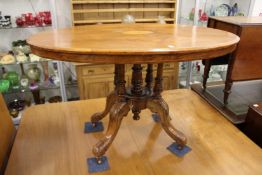 A Victorian inlaid walnut oval breakfast table.