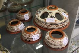 Mary Wondrausch for The Compton Pottery, an unusual terracotta and glazed egg holder with four