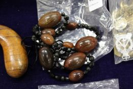 A bead necklace, possibly rhino horn.