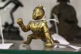 A small eastern bronze figure of baby Ganesh.