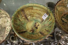 Decorative painted and incised Islamic pottery bowl.