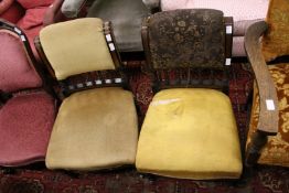 A pair of Victorian ebonised and burrwood inlaid low upholstered chairs.