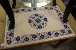 An inlaid marble table top with stand.