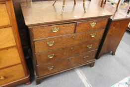 An 18th century oak straight front chest of two short and three graduated long drawers on bracket