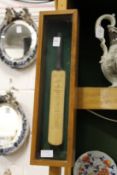 A small presentation cricket bat, Australia 1964, in a glazed display case.