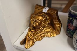 A cherub wall bracket.