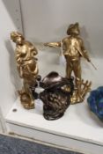 A pair of gilt painted spelter figures and a small metal vase.