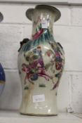A Chinese baluster shaped vase decorated with warriors (rim chipped).