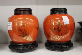 A pair of Chinese ginger jars, orange ground with gilded decoration complete with covers and