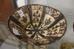 An early Islamic painted pottery bowl.