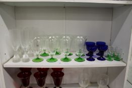 Colourful glassware to include a set of eight etched glass drinking glasses and four Bristol Blue