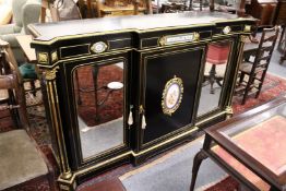 A very good 19th century ebonised and ormolu mounted break front credenza inset with porcelain