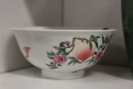 A small Chinese bowl decorated with peaches and bats.