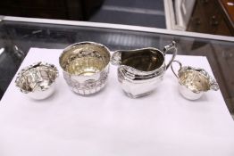 A group of small silver items to include a milk jug, a small cream jug and matching sugar bowl and
