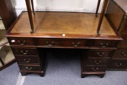 A reproduction mahogany pedestal desk.