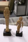 An Egyptian Shabti and a similar figure.