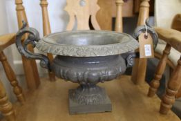 A small cast iron urn.