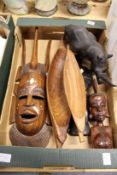 A carved African mask and similar items to include a rhinoceros.