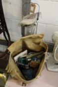 An old army bag containing miscellaneous items together with a camping gas bottle and similar lamp.
