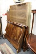 A 19th century French walnut lit bateau, or sleigh bed.