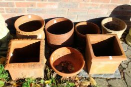 A small collection of terracotta plant pots.