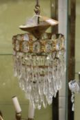 A brass and cut glass bag chandelier.