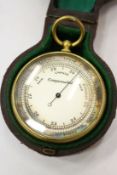 A cased pocket barometer.