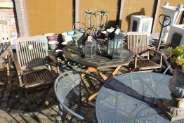 A folding garden table and a pair of armchairs.