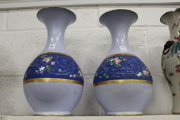 A large pair of pale blue ground vase with a band of rich blue and floral decorated decoration.