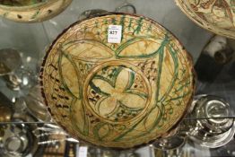 Decorative painted and incised Islamic pottery bowl.