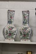 A pair of Chinese floral decorated baluster shaped vases.