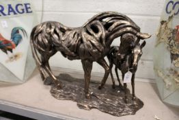 An unusual cast composite model of a mare and foal.
