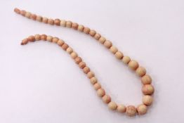 A stained ivory bead necklace.