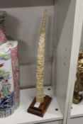 An African marine ivory carving on stand.