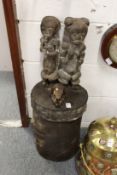 An unusual African box and cover mounted with a pair of carved wood figures and a skull.