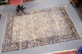 A Persian Kerman carpet.