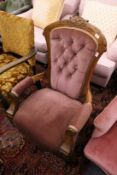 A Victorian beech framed button upholstered open armchair.