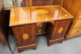 A 19th century inlaid mahogany kneehole desk.